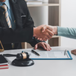 Handshake over legal documents and gavel